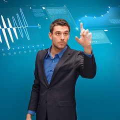 Image showing businessman working with imaginary virtual screen