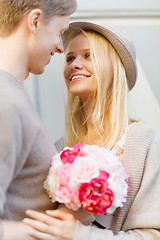 Image showing happy couple with flowers in the city