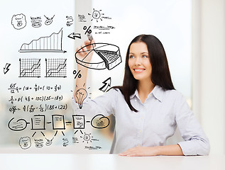 Image showing smiling woman drawing plan on virtual screen