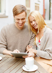 Image showing couple looking at tablet pc in cafe