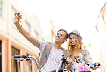 Image showing couple with bicycles taking photo with camera