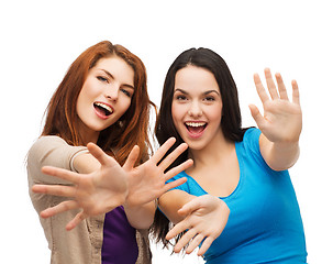 Image showing two smiling girls showing their palms