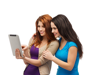 Image showing two smiling teenagers with tablet pc computer