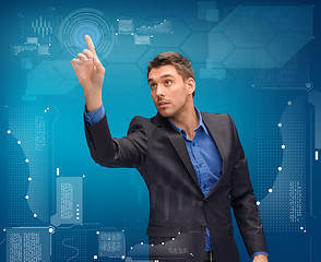 Image showing businessman working with imaginary virtual screen