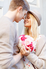 Image showing happy couple with flowers in the city