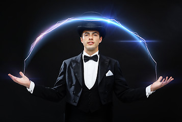 Image showing magician in top hat showing trick