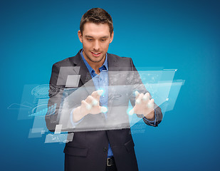 Image showing businessman working with imaginary virtual screen