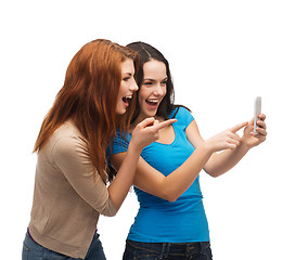 Image showing two smiling teenagers with smartphone