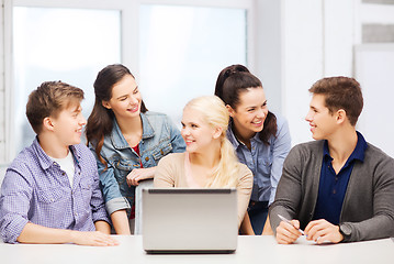 Image showing smiling students with laptop at school