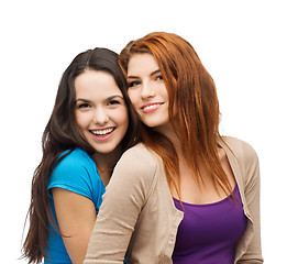 Image showing two smiling girls hugging