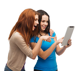 Image showing two smiling teenagers with tablet pc computer