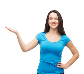 Image showing teenager holding something on the palm of her hand