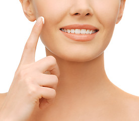 Image showing beautiful woman applying moisturizing cream