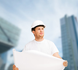 Image showing male architect in helmet looking at blueprint