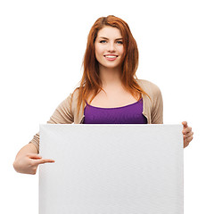 Image showing smiling young girl with blank white board