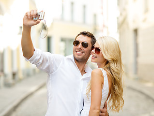 Image showing travelling couple taking photo picture with camera