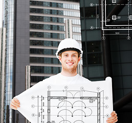 Image showing male architect in white helmet with blueprint