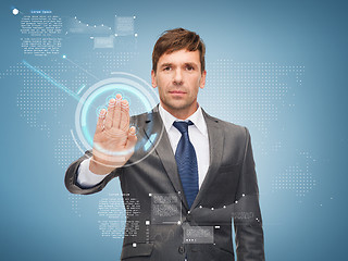 Image showing attractive buisnessman working with virtual screen