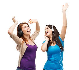 Image showing two laughing girls with headphones dancing