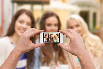 Image showing close up of hands taking picture with smartphone