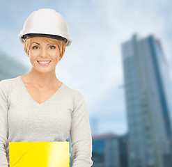 Image showing female contractor in helmet with bluepring