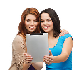 Image showing two smiling teenagers with tablet pc computer