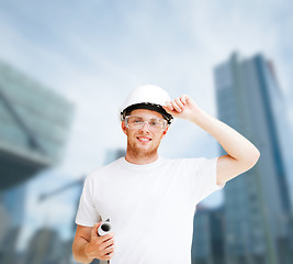 Image showing male architect in helmet with blueprint