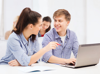 Image showing two smiling students with laptop computer