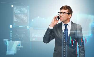 Image showing buisnessman with cell phone and forex chart