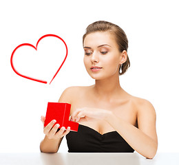 Image showing woman with diamond earrings and gift box