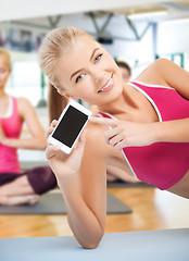 Image showing woman lying on the floor with smartphone