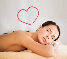 Image showing beautiful woman in spa salon with hot stones