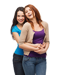 Image showing two laughing girls hugging