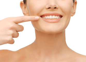 Image showing beautiful woman pointing to teeth