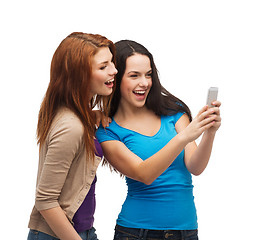 Image showing two smiling teenagers with smartphone