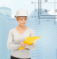 Image showing female contractor in white helmet with files