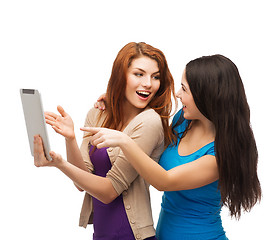 Image showing two smiling teenages with tablet pc computer