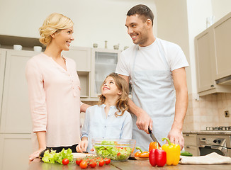 Image showing happy family making dinner in kitchen