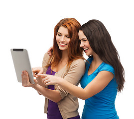 Image showing two smiling teenagers with tablet pc computer