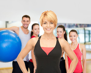 Image showing group of smiling people exercising in the gym