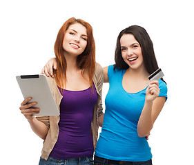 Image showing two smiling girls with tablet pc and credit card