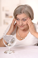 Image showing Senior woman doing makeup