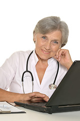 Image showing Elderly woman doctor sitting with laptop