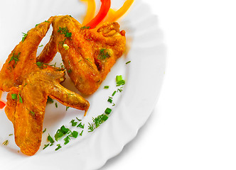 Image showing Fried chicken wings with legs his chopped pepper, onion and fenn