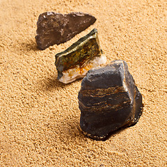 Image showing three stones in the sand texture