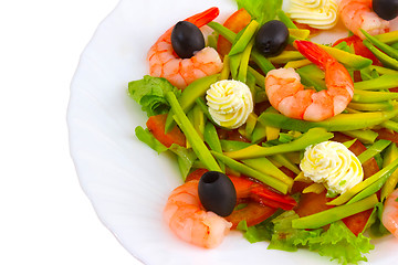 Image showing Fresh shrimp with olives and cream close up on white background