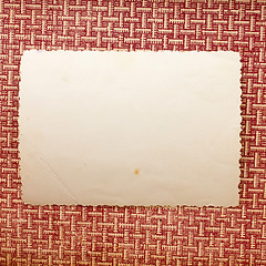 Image showing piece of old paper lying on a brown texture background