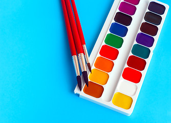 Image showing brushes watercolors paints children on blue background