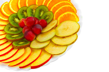 Image showing Salad apples oranges grapes kiwi fruit slices on a plate isolate