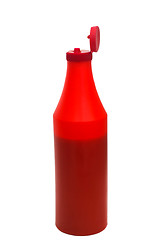 Image showing red plastic ketchup bottle isolated on white background